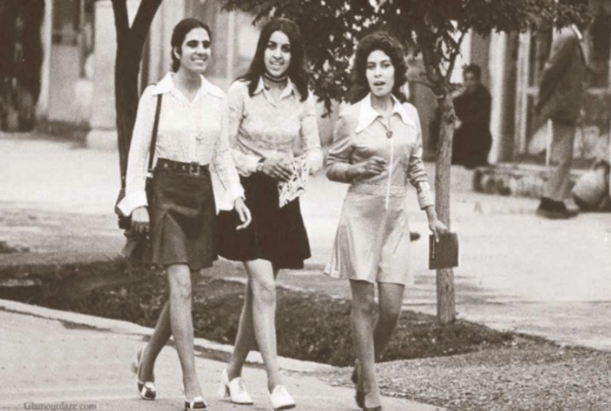 Young Afghan women walking in 1960s Western street fashion.